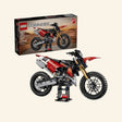 LEGO® Technic Ducati Desmo450 MX Factory set shown with retail box and completed red, black, white, and gold dirt bike model on a display stand, featuring Ducati branding, number 222 graphics, knobby tires, and age 10+ guidance.