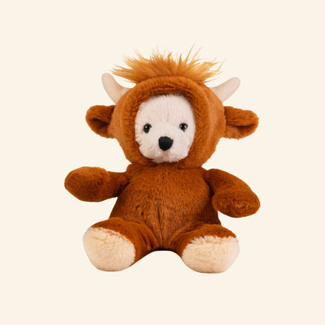 Keycraft Little Dress Up Bear – Highland Cow plush shown seated in a soft brown Highland cow costume with cream bear face, cream paws, small horns, floppy ears, and fuzzy orange hair on the removable hood.