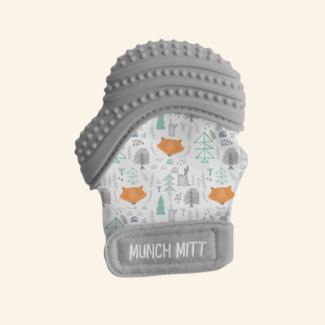 Malarkey Kids Munch Mitt shown in gray with a woodland animal print fabric mitten, textured gray silicone teething top, adjustable wrist strap, and soft mitten shape.