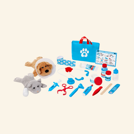 Melissa & Doug Examine & Treat Pet Vet Play Set contents arranged outside the box, including a plush dog with cone collar, plush cat, blue pet vet tote bag, stethoscope, bandage roll, medicine bottles, syringe, thermometer, and exam checklist.