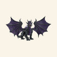 Schleich® ELDRADOR® Creatures Shadow Dragon shown from the front with wide black-and-purple wings, fierce face, sharp claws, and spiked fantasy creature details.