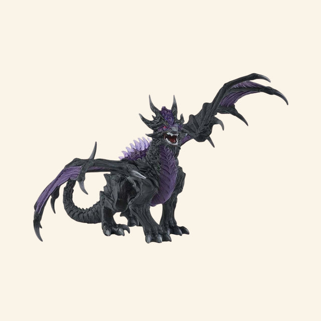 Schleich® ELDRADOR® Creatures Shadow Dragon shown from the side with raised wings, black body, purple chest, spiked back, and long dragon tail.