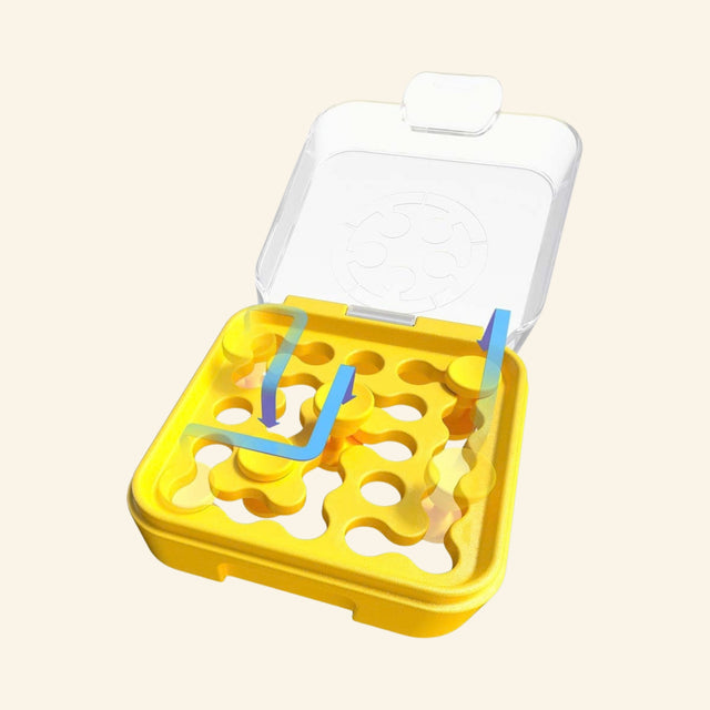 SmartGames IQ Mini yellow puzzle case shown open with puzzle pieces placed into the board and the clear lid raised for travel-friendly play.