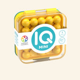 SmartGames IQ Mini shown in yellow retail packaging with compact puzzle case, yellow puzzle pieces, IQ Mini logo, and age 6+ guidance.