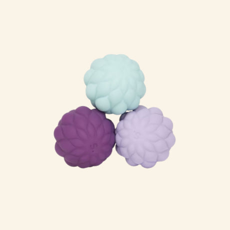 Three Speks Odds Puffs magnetic fidgets in pale blue, purple, and lavender, featuring rounded clustered textures resembling soft puffs