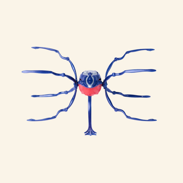 Spin Master HEX BOTS Skitter Bot Spider shown from the front in a blue and red colorway, highlighting the spider-like body, long legs, and pointed rear detail.