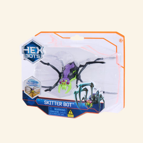 Spin Master HEX BOTS Skitter Bot Spider shown in retail packaging with a purple, black, and green robot spider inside a clear blister package, HEX BOTS logo, Skitter Bot label, and age 4+ guidance.