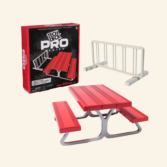 Spin Master Tech Deck Pro Series Daily Grind Pack 2.0 shown with retail box, red picnic table fingerboard obstacle, white bike-rack-style rail, real metal alloy callout, and age 6+ guidance.