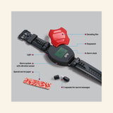 Thames & Kosmos Spy Labs: 9-in-1 Spy Watch laid flat with labels pointing to the decoding film, stopwatch, alarm clock, light, vibration alarm system, secret message paper, and two capsules for hidden messages.