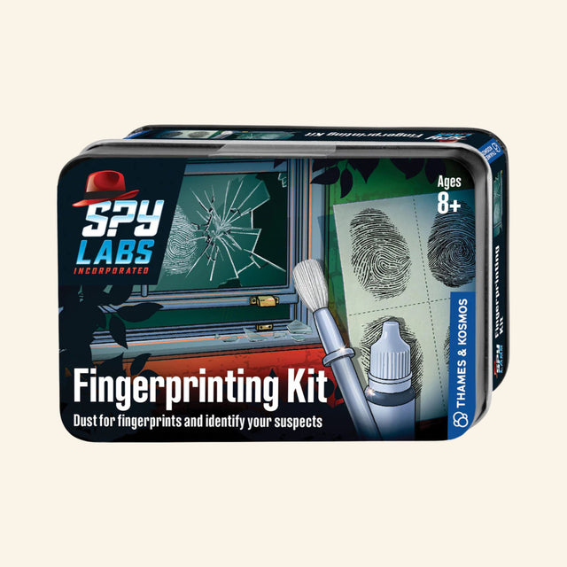 Thames & Kosmos Spy Labs: Fingerprinting Kit metal tin showing fingerprint powder, brush, lifted fingerprints, broken glass investigation artwork, and “Dust for fingerprints and identify your suspects” text.