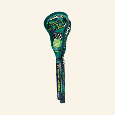 Waboba Moon Ball Mini Lacrosse – Urban LAX set in retail packaging showing one green-and-blue mini lacrosse stick with netting and a mini Moon Ball inside the head.